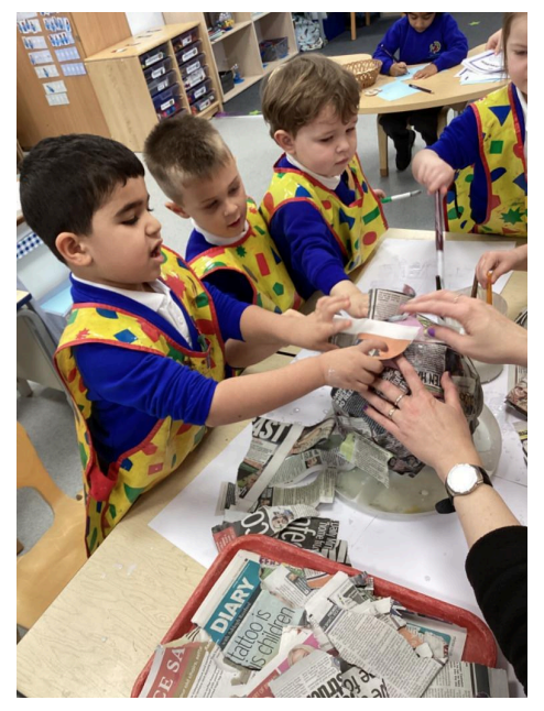 Students creating paper mache items