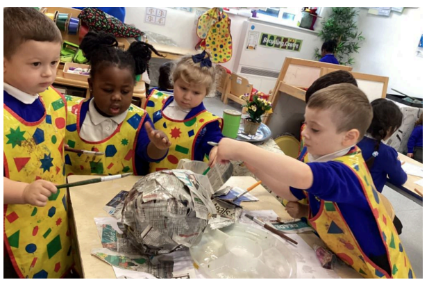 Students creating paper mache items