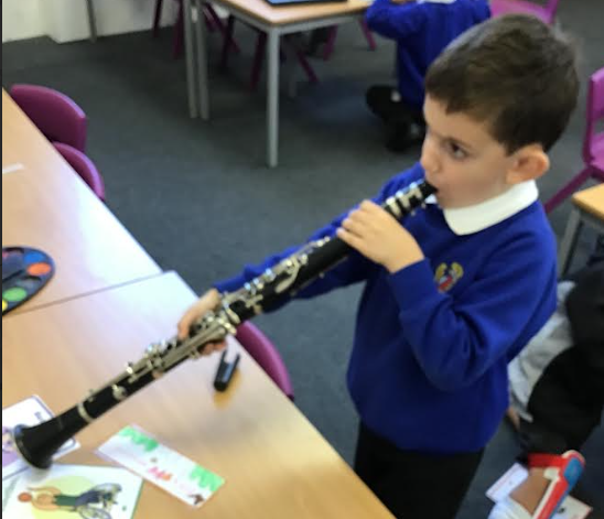 a boy is learning to play the clarinet.