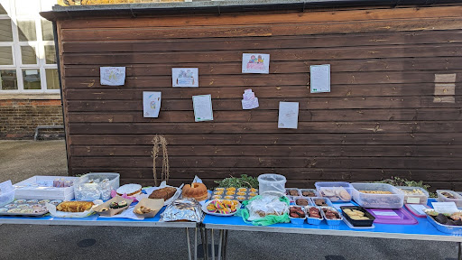 Photo of a selection of baked treats made by Reception class, ready to be sold at a bake sale.