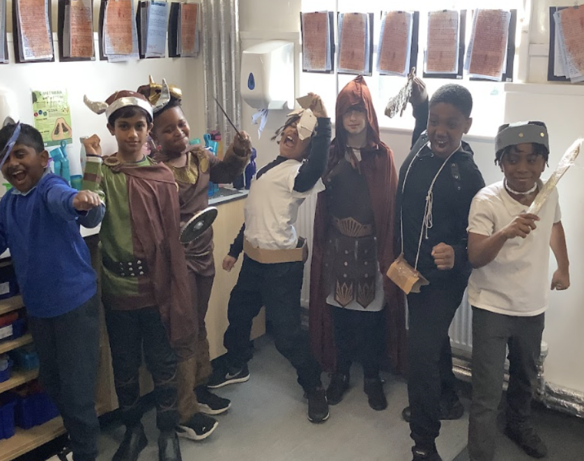 A group of pupils are pictured posing for the camera, whilst dressed up as Vikings for Year 5 Viking Day.