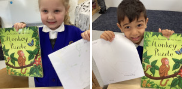 Students showing off their work and holding a book
