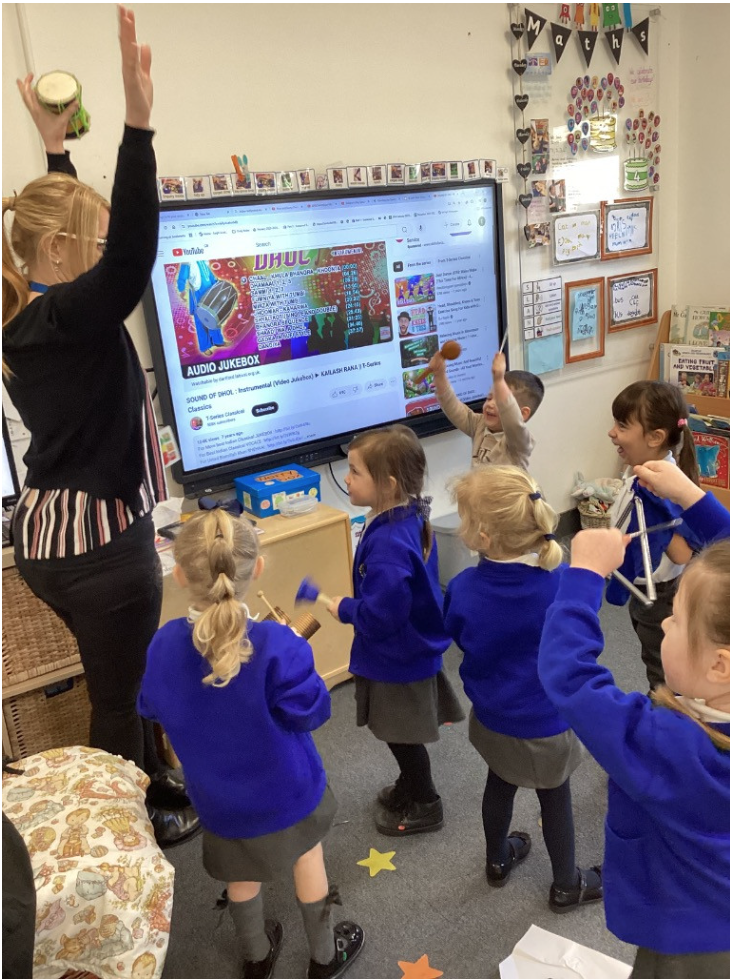 Students standing up doing an activity with their teacher