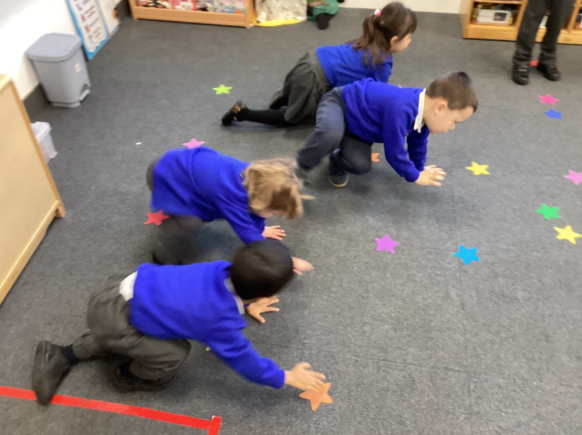 Students on the floor partaking in an activity
