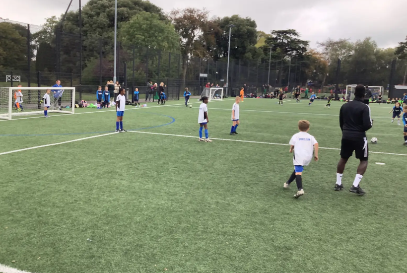 A football match featuring girls and boys taking place