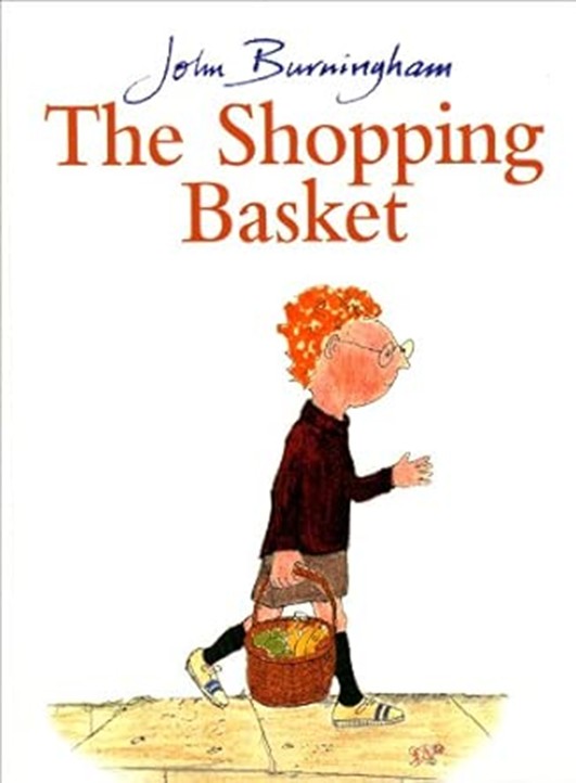 he book cover for "The Shopping Basket" by John Burningham. It illustrates a young boy with red hair and glasses walking along a pavement, carrying a brown wicker basket filled with fruit.