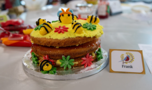 A cake decorated with bees and flowers